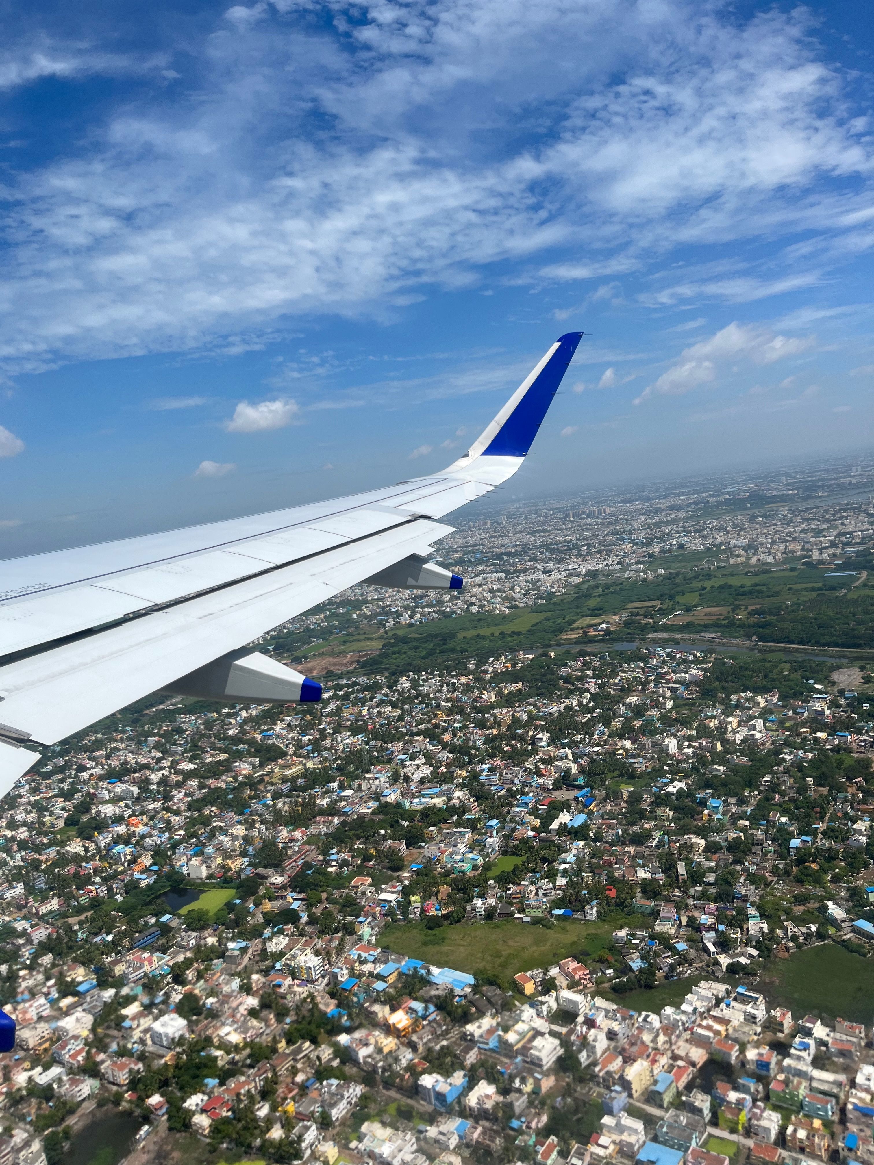 A flight well above a city but still in it's upward takeoff trajectory