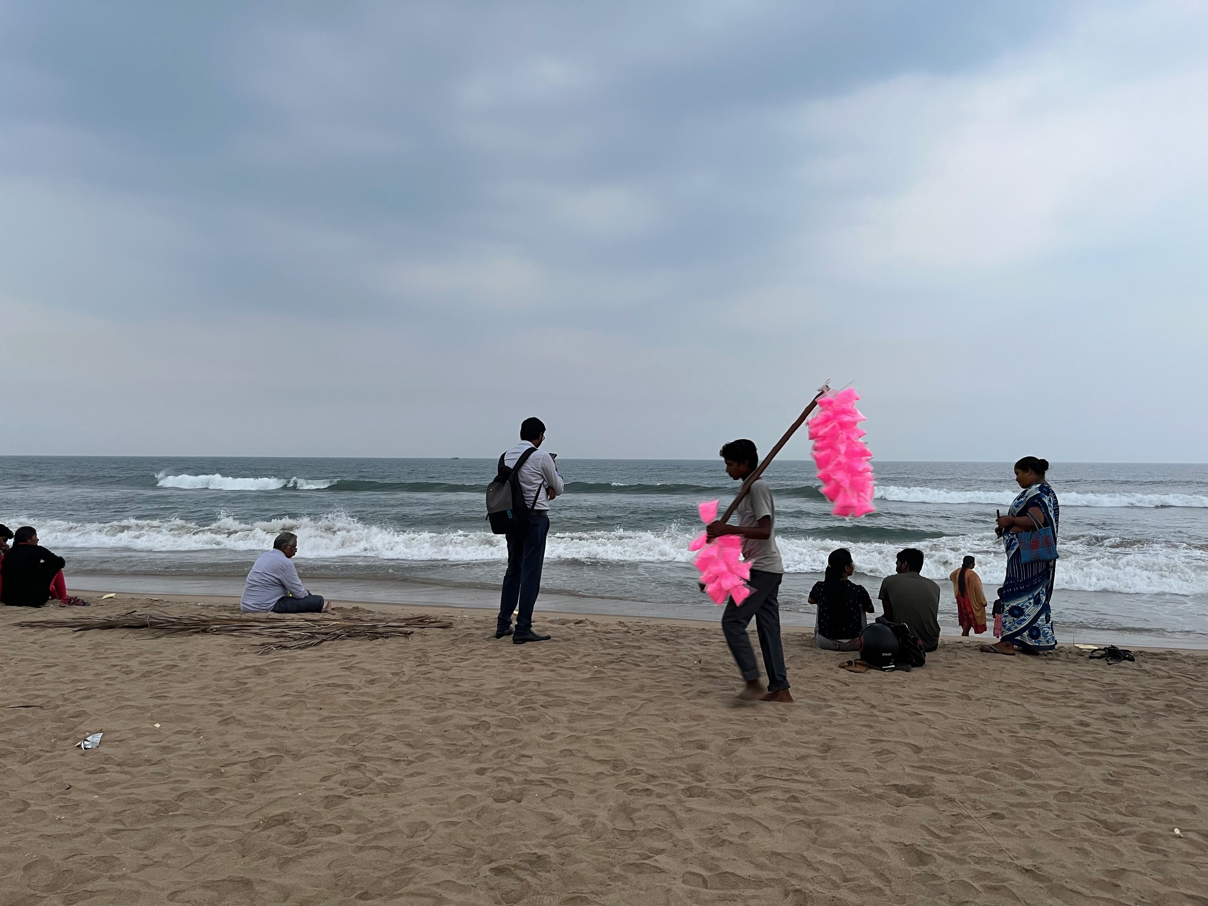 A young boy selling colored sweet in a beach