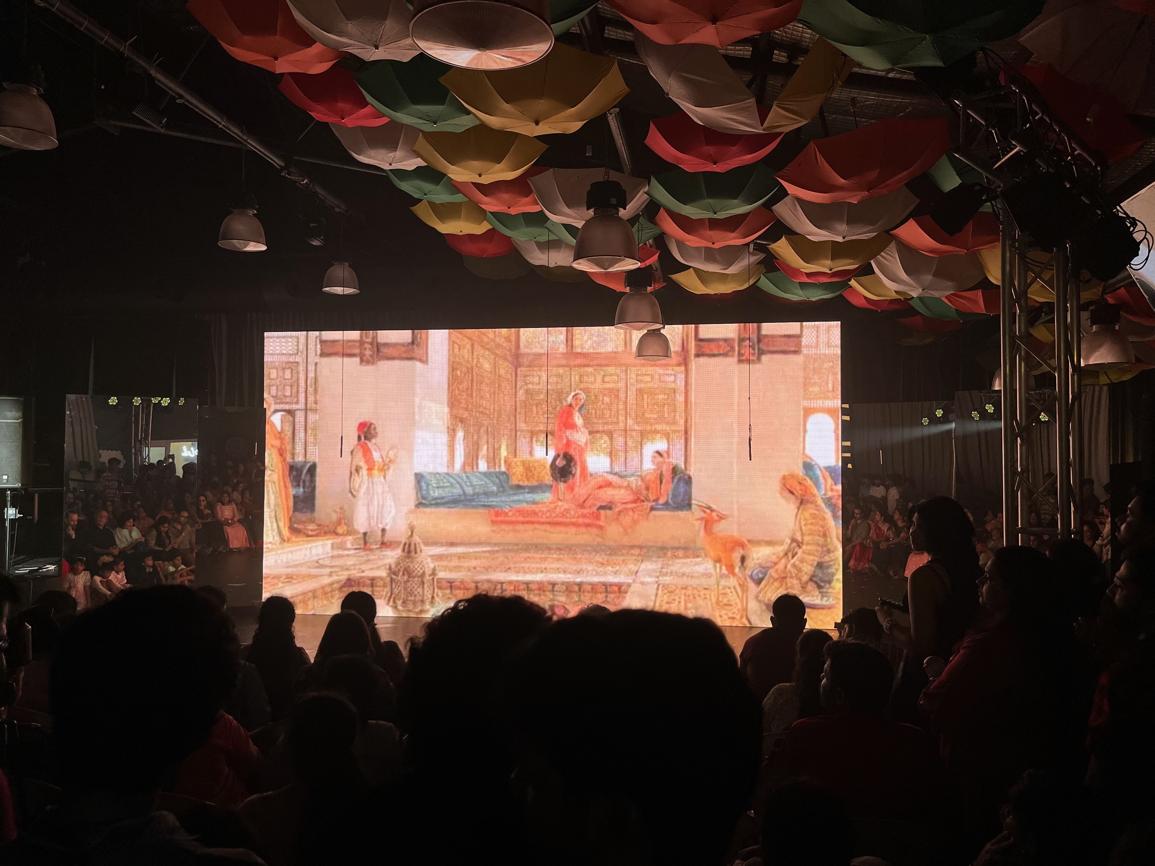A theater full of people watching a something that's being projected